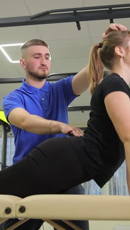 physical therapist assisting patient with back exercises