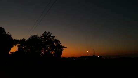 Mesmerizing-footage-of-driving-at-twilight,-with-the-beautiful-sunset-and-dusk-colors-in-the-background