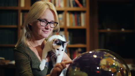 una mujer mira un hermoso globo en la biblioteca