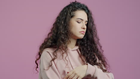 woman with curly hair in a hoodie
