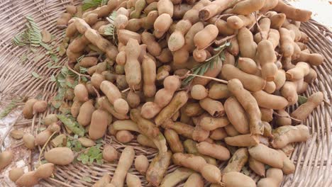 hand-held shot of tamarind on a basket