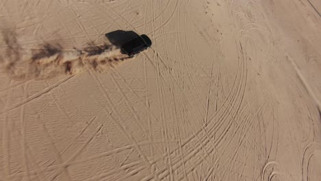 slow motion fpv drone clip of off road car in the desert