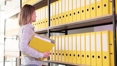 woman holding folders in office