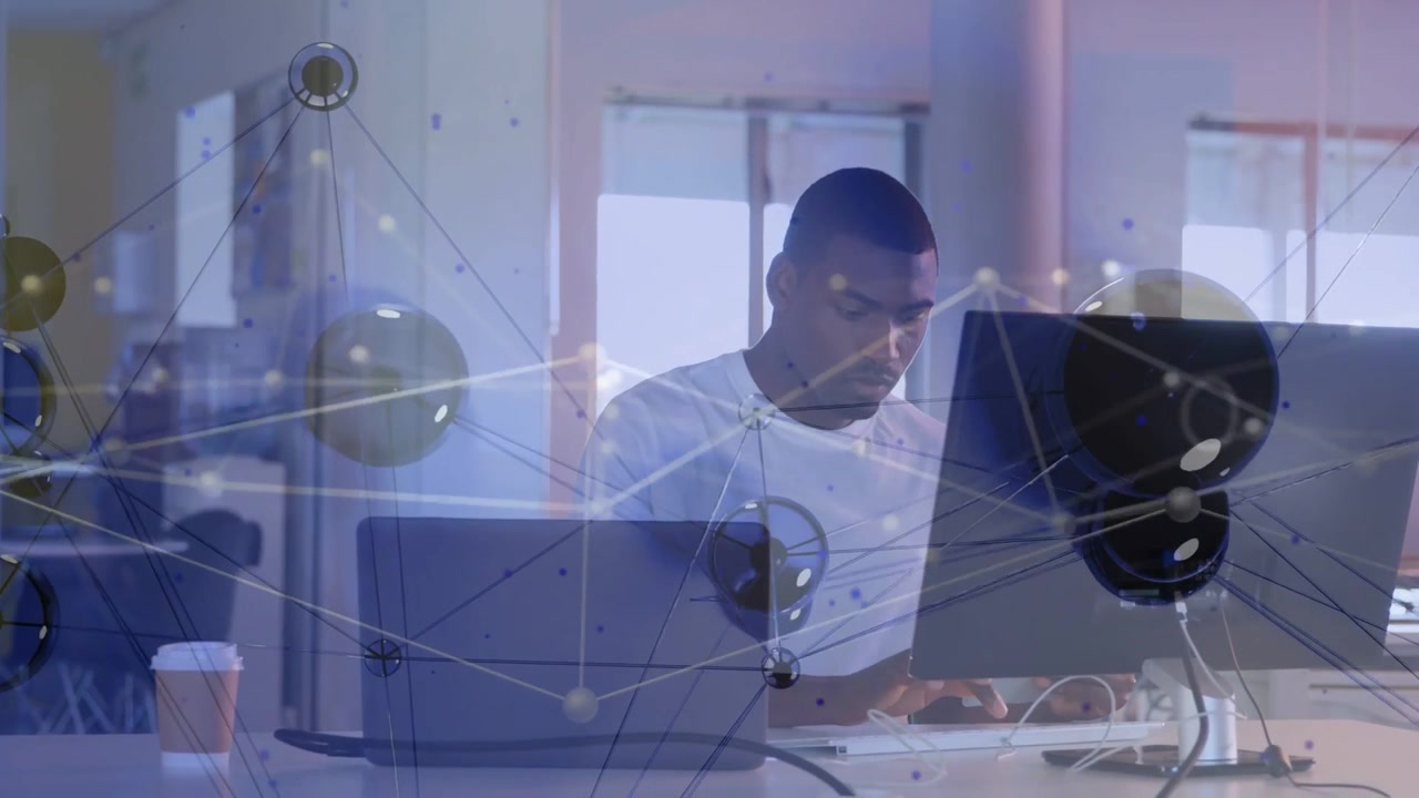 Vertical video: Typing adult man in white tee reading screens and typing at desk, network overlay