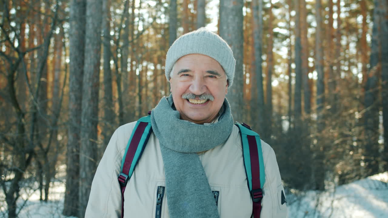 Smiling Senior Man in Winter Forest