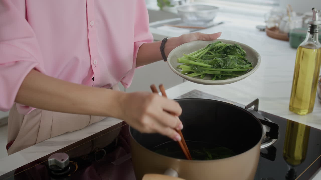 Housewife Cooking Dish with Boiled Greens