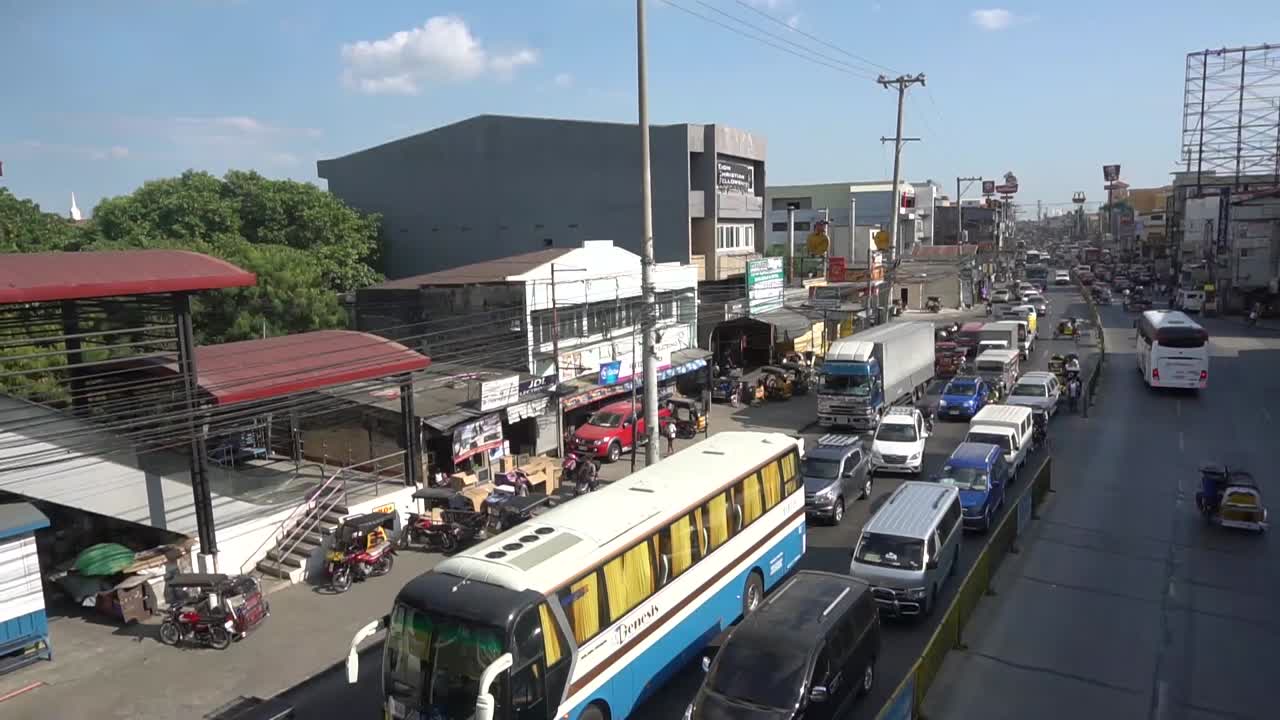 Stabilized cinematic shot from a bridge of vehicle traffic
