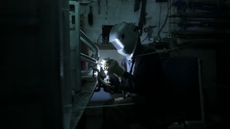 Welder-welding-an-industrial-stainless-steel-part-together