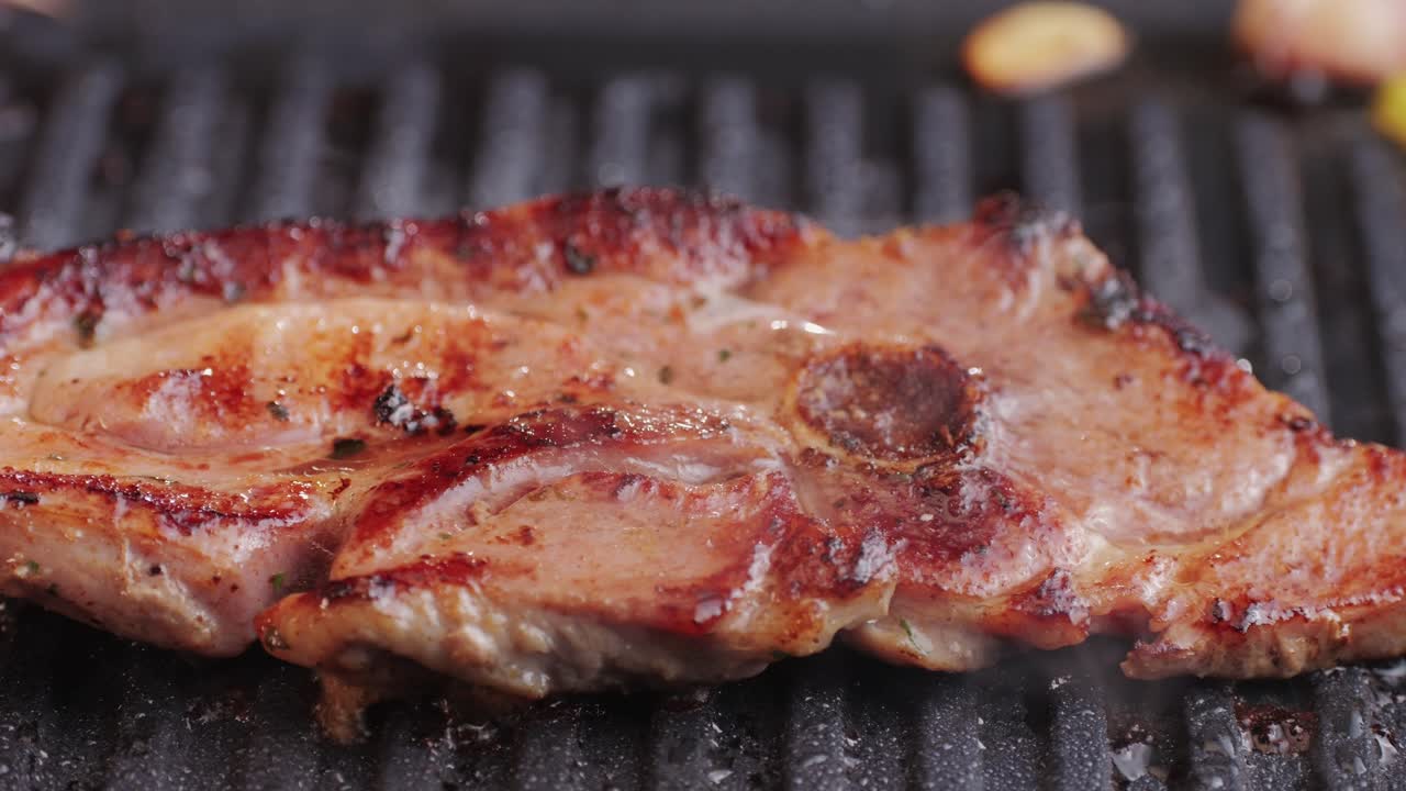 Cooking raw turkey meat in spices with garlic and greens on grill close-up. Fry chicken or turkey slice on frying pan Grilled chicken, duck, turkey kebab with vegetables.