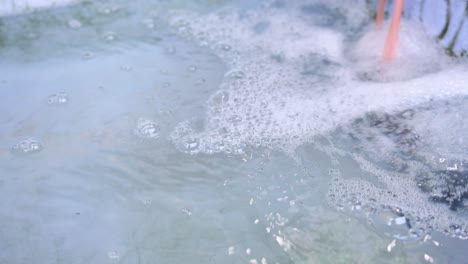 water surface agitated with bubbles and foam