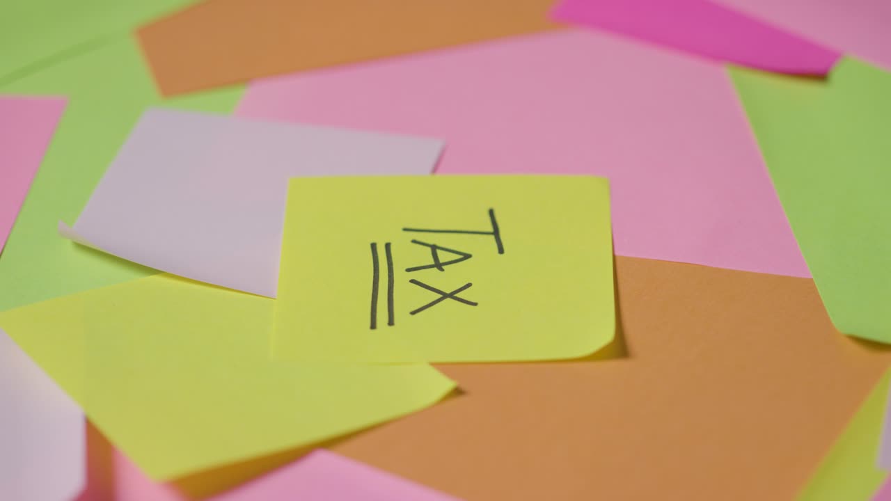 Business Concept Of Revolving Sticky Notes With Tax Written On Top Note 1