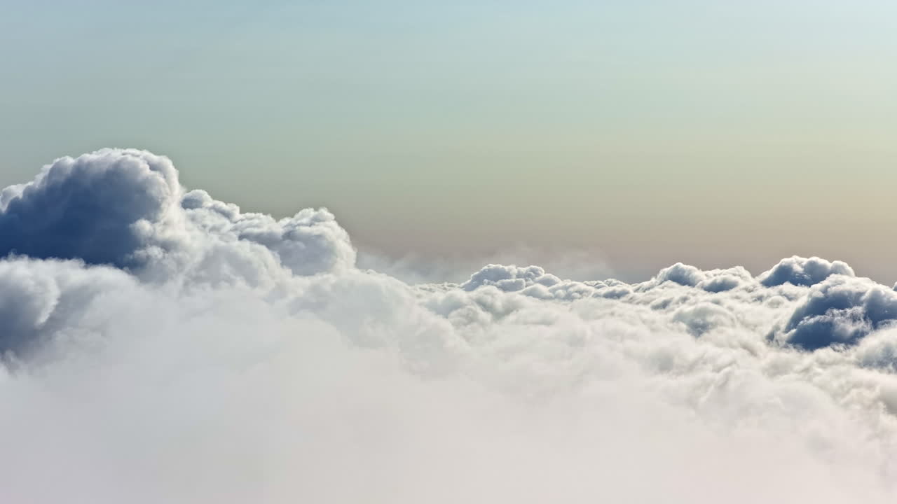 A breathtaking high-altitude aerial view of a vast sea of soft, white cumulus clouds, creating a peaceful and dreamlike skyscape that evokes a sense of freedom and serenity