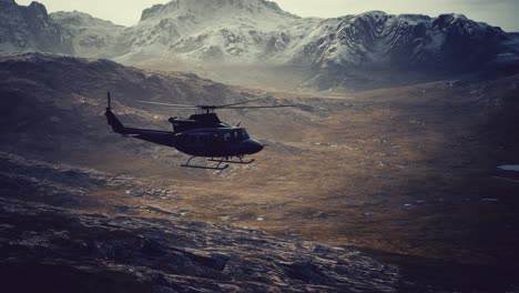 slow motion vietnam war era helicopter in mountains