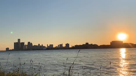 amazing nature and sunset time lapse by the river and sun sets behind the buildings