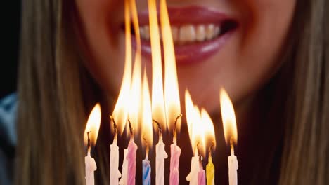 birthday boy blows out candles on a birthday cake