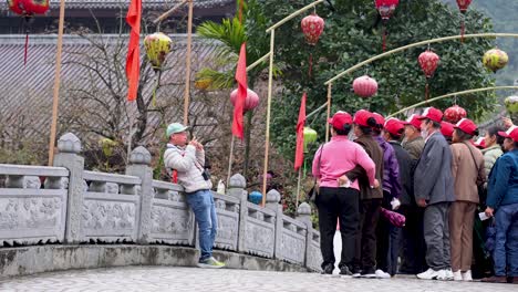 tourists in pink hats exploring a historic bridge