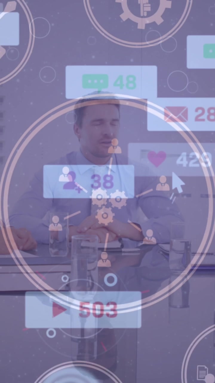Animation of digital icons spinning over diverse businesspeople discussing together at office
