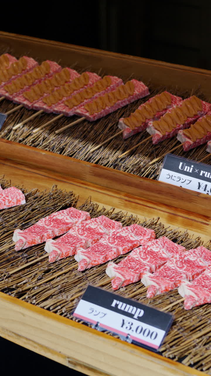 Close up of multiple pieces of Wagyu beef at the Tsukiji Fish Market in Japan. Vertical