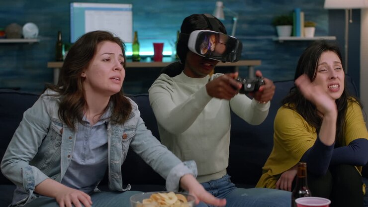African woman losing online game while wearing virtual reality headset
