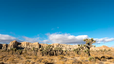 the unique geological features of the red rock canyon cliffs with dramatic cloudscape overhead - time lapse