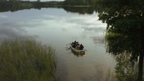 group of people with a boat starting a journey on the lake