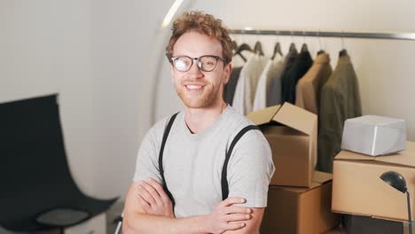 stylish handsome man puts glasses on camera and smiles