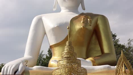 tourists visiting a large, tranquil buddha statue