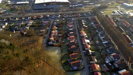 aerial shot of housing development at sunrise in sweden, houses in urban community