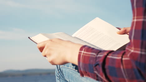 Close-up-of-The-Bible-with-lake-behind