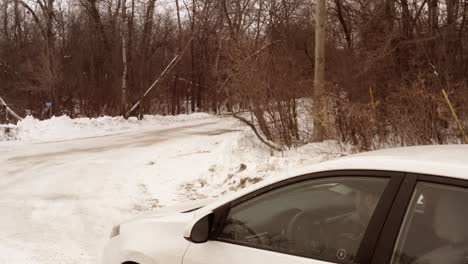 man getting out of a car on a rural forest road