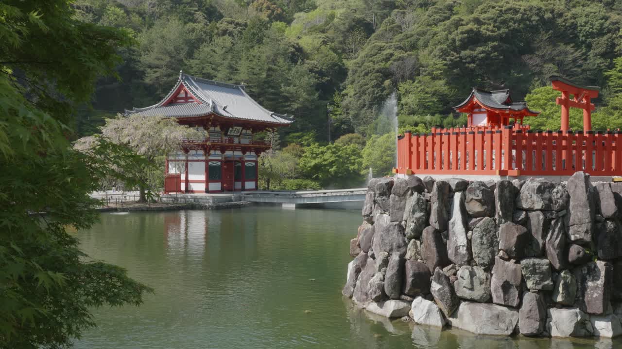 Entry gate, shrine and pond on a sunny day at Katsuoji Temple, Osaka. Japan