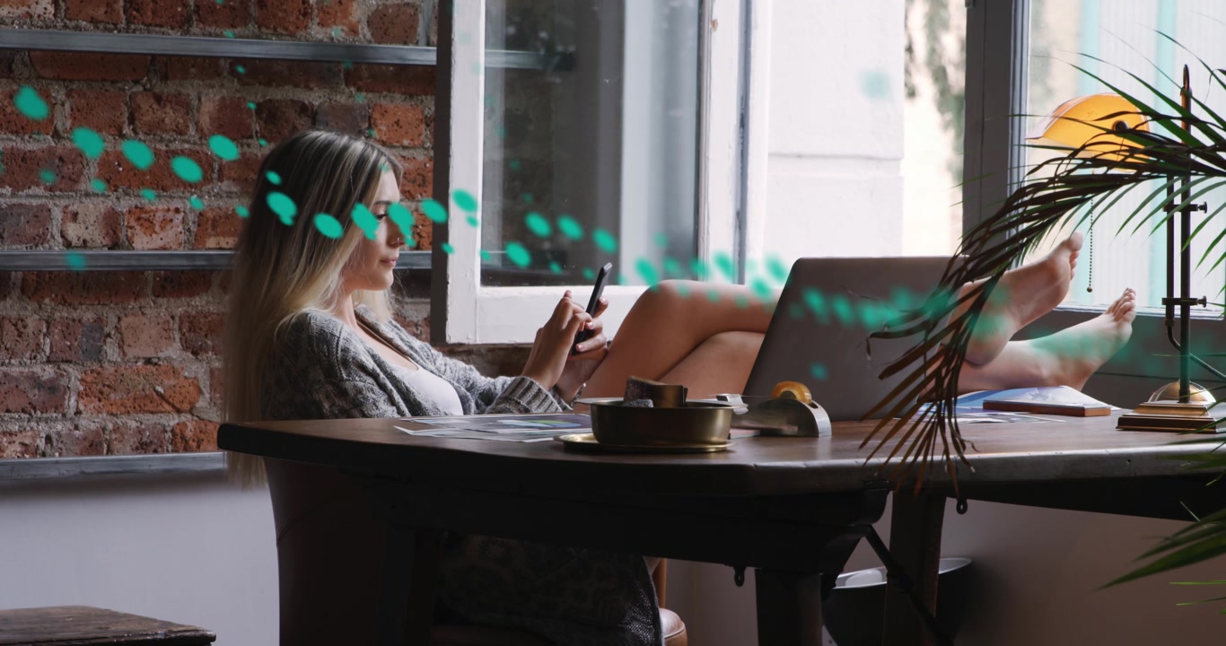 Woman reclining in loft scrolling phone, reviewing metrics and causing teal overlay revealing data