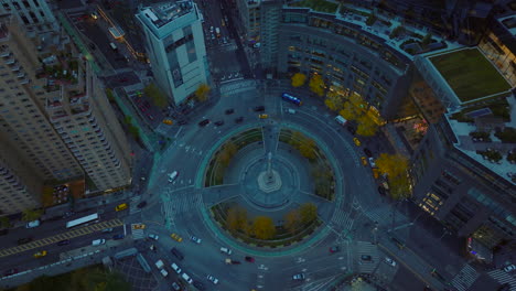 High-angle-shot-of-multilane-roundabout-circuit-in-city.-Various-vehicles-passing-through-Columbus-Circle.-Manhattan,-New-York-City,-USA