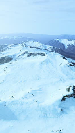 aerial view of snow-covered mountains in winter