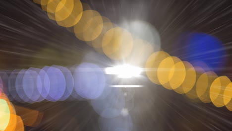 digital animation of colorful bokeh light against bright spot of light on dark background