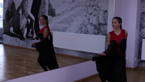 Professional-female-dancer-dances-on-the-dance-floor-in-front-of-the-mirror