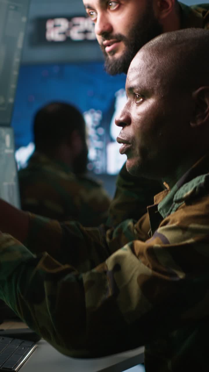 Vertical video Army telecommunications operators inputting data on systems