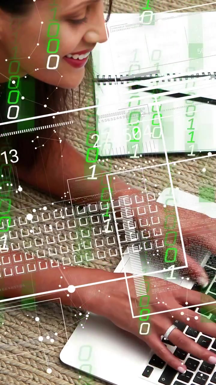 Vertical video: Woman typing on laptop on rug, studying tech while HUD overlay growing around hands
