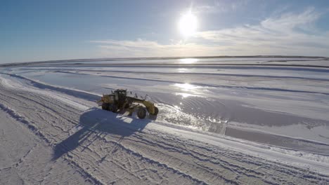 Aerial-drone-shot-of-a-traktor-separating-salt-to-be-harvested-in-the-salt-flats-by-solar-evaporation-in-Guerrero-Negro,-Ojo-de-Liebre-lagoon,-Biosphere-Reserve-of-El-Vizcaino,-Baja-California-Sur