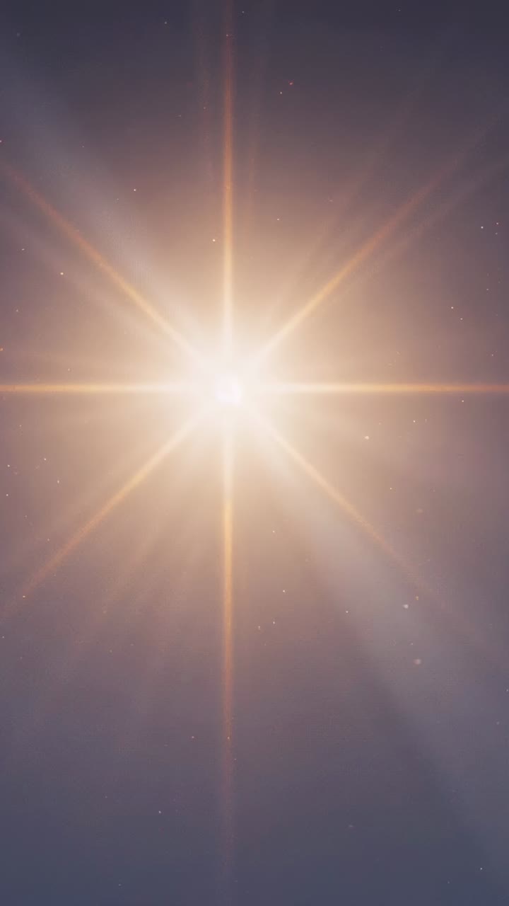 Vertical video: Showing first frame bright light casting star rays from lens diffraction in sky