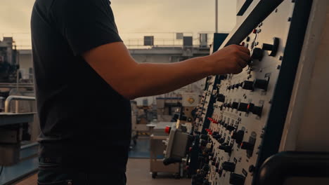 person operating a control panel in an industrial setting