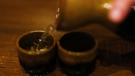 sake being poured into two cups