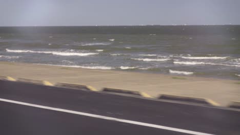 slow motion footage of galveston beach along seawall