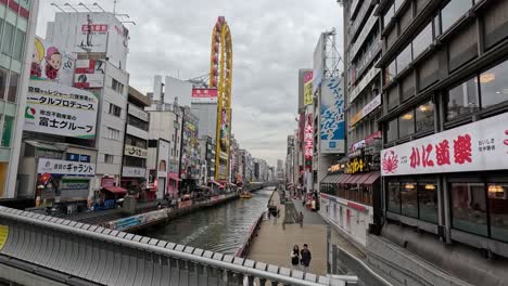 time-lapse of a crowded japanese cityscape with canal.