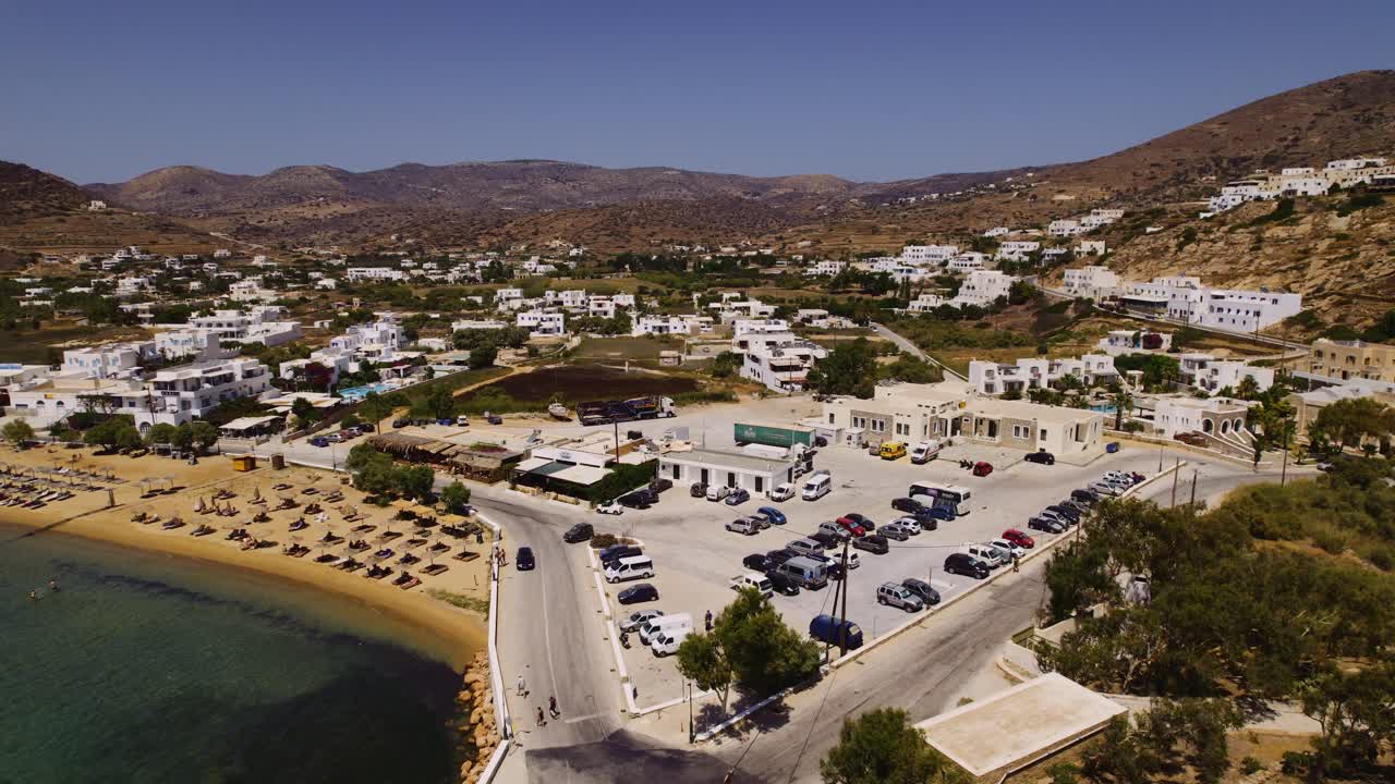 Aerial view of a picturesque Greek island village with beach and clear turquoise waters