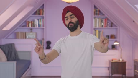 happy sikh indian man dancing and doing bhangra