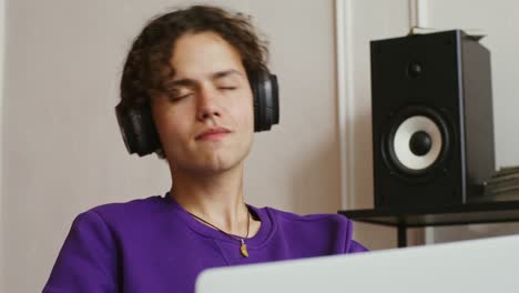 teenager relaxing with headphones and laptop