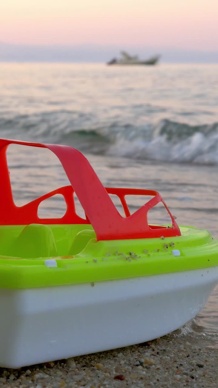 Toy boat on the beach