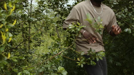 man peeing behind bushes