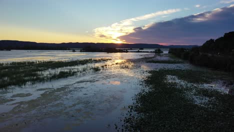 sunset over a tranquil marsh and lake